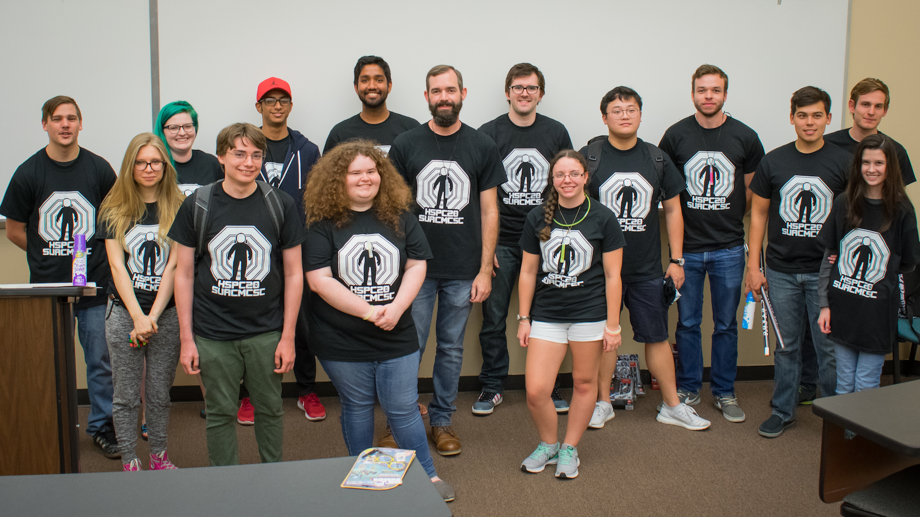 A group shot with everyone in black t-shirts with white event logo