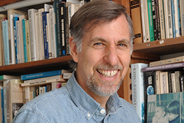 portrait in front of a bookcase