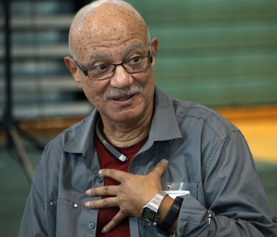 portrait of him talking with his hand on his chest