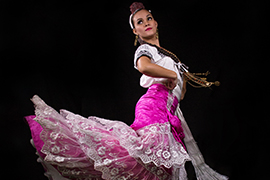 Janereth Vargas Cervera dances in a colorful ornate costume from her home country of Mexico.