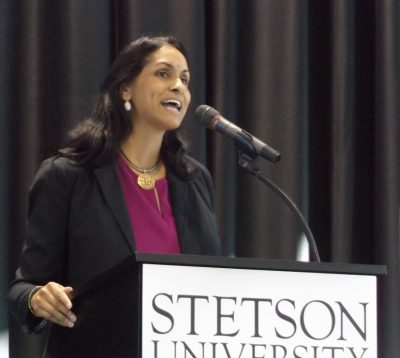 Rajni Shankar-Brown stands and speaks at a podium that says Stetson University