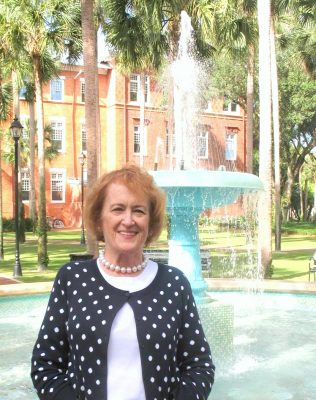 Diane Disney poses in front of the fountain in Palm Court on Stetson's DeLand campus