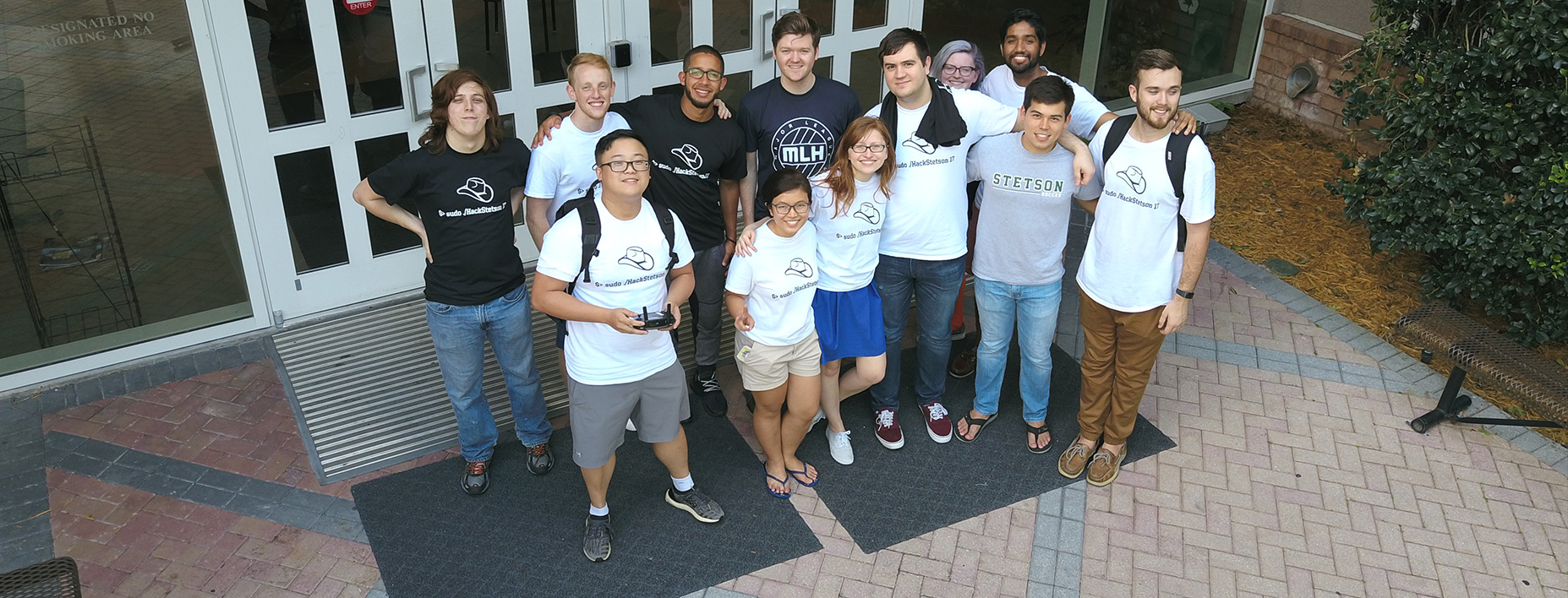A large group shot of students wearing their hackathon t-shirts.