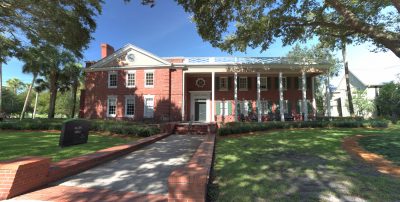 Exterior panoramic shot of brick faced Allen Hall with white colonial support beams out front