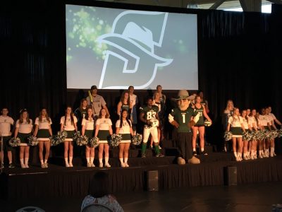 Cheerleaders and other Stetson athletes join John B., the mascot, on stage.