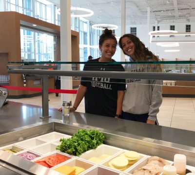 The two women stand at the deli counter in the expansive new Commons Dining Hall