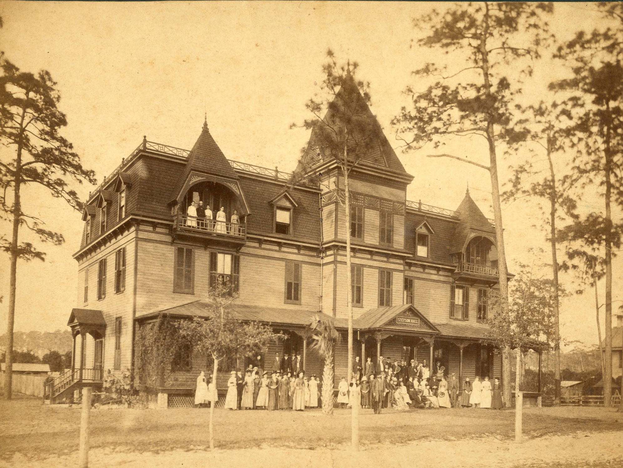 old grainy photo from the 1800s of students in front of former Stetson Hall.
