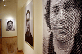 black and white portraits hang on the walls of the Hand Art Center