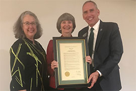 Linda Davis holds framed proclamation with Wendy LIbby and Joe Cooper