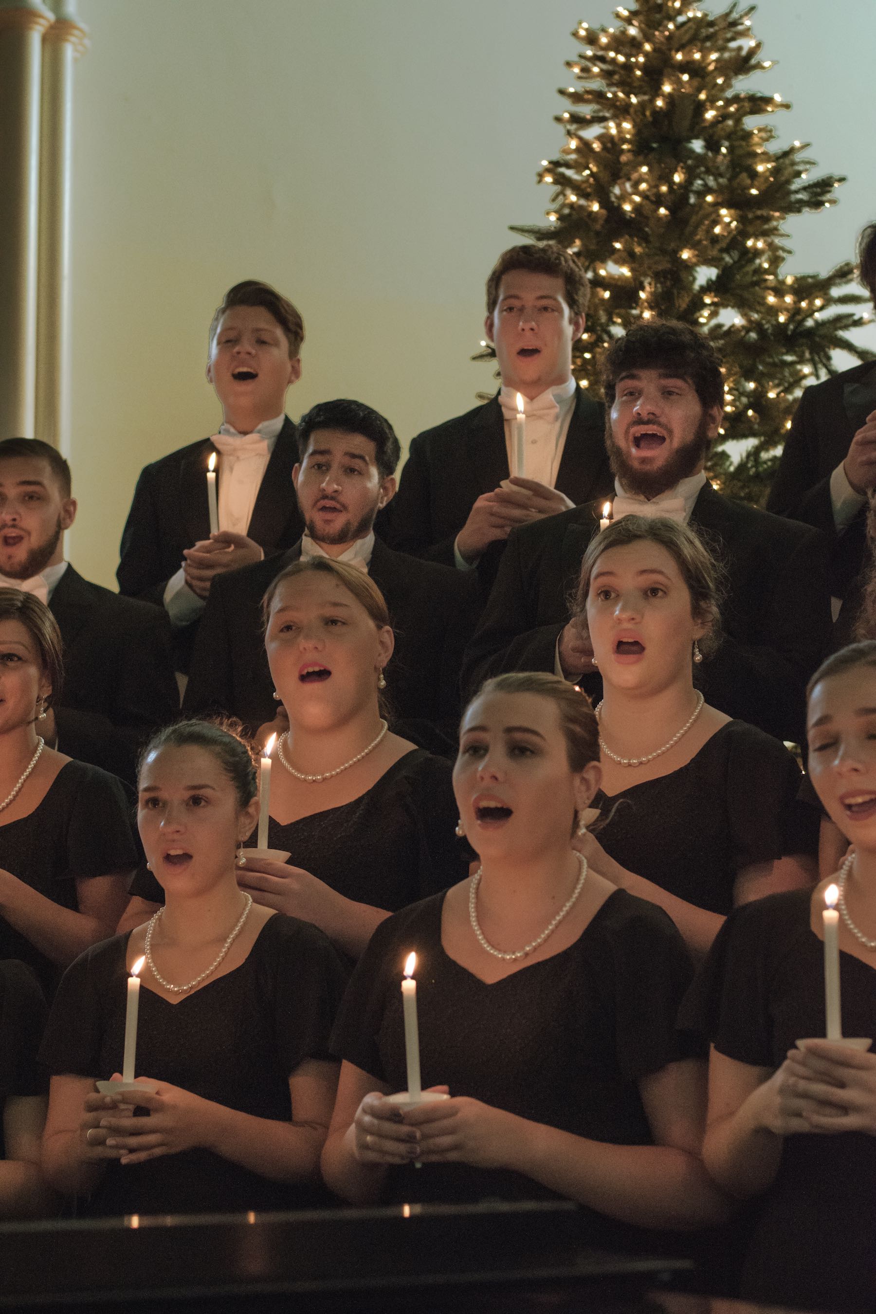 Stetson School of Music Concert Choir sings in formal dress holding candles