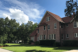 Exterior of two-story brick house on campus for the Stetson Hillel House.