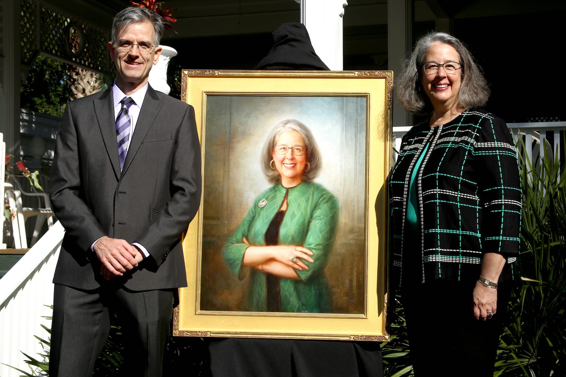 the two stand next to the painting