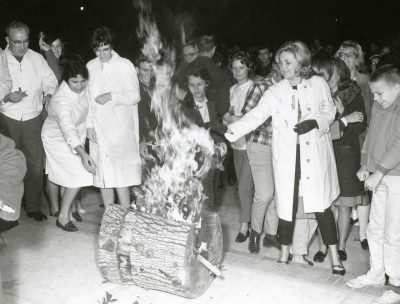 Students gather around the burning Yule Log during the Yule Log ceremony in this 1965 black and white photo.