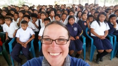 She takes a selfie with a crowd of Honduran school children behind her.