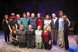 A big group shot of cast and crew with creators of the play inside the Stetson theatre.