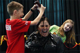 a boy pours chocolate syrup on a girl at Hatterthon