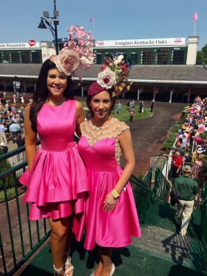 The two sisters stand side-by-side at the Kentucky Derby in bright pink dresses and fancy hats