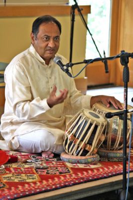 Indian musician "Nandu" Muley talks as he sits in front of tabla, Indian drums