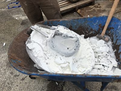 Bronze hat is still covered by a lot of white ceramic molding