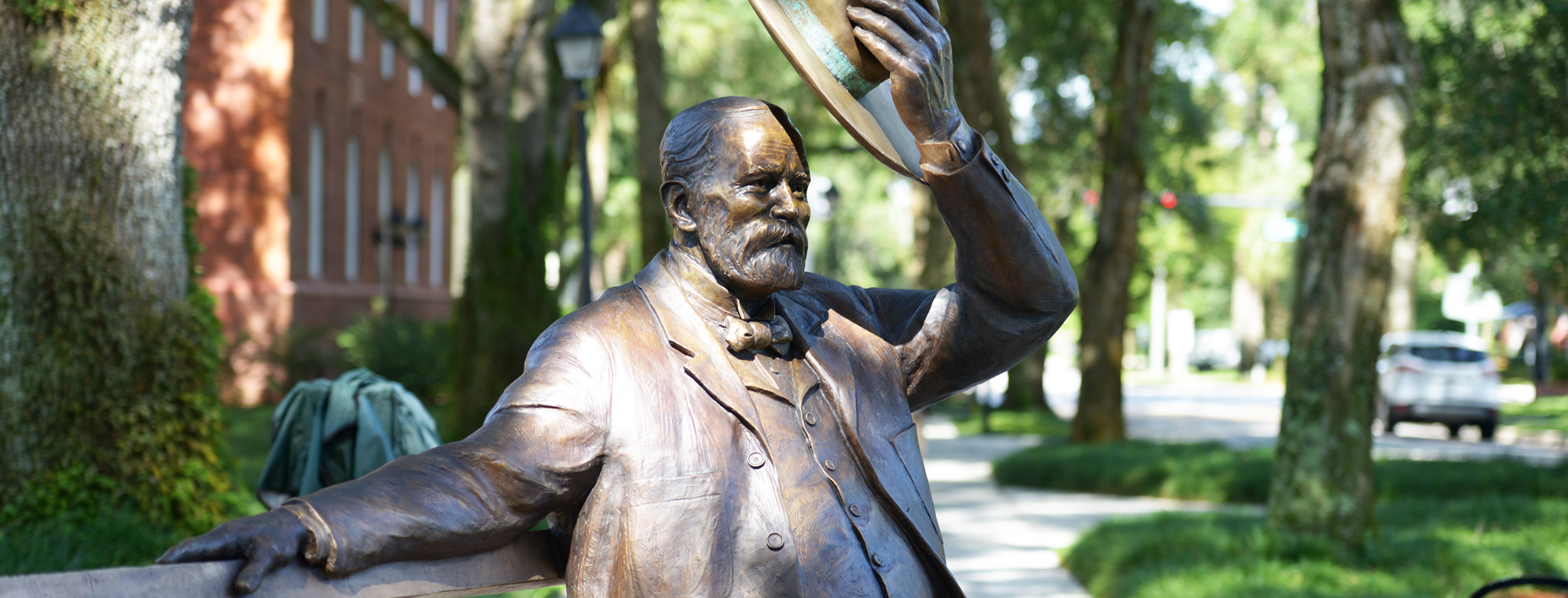 Side view of John B. Stetson tipping his hat statue
