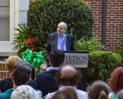 Alan Ginsburg speaking at the podium