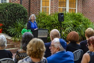 Wendy Libby at the podium addressing the crowd.