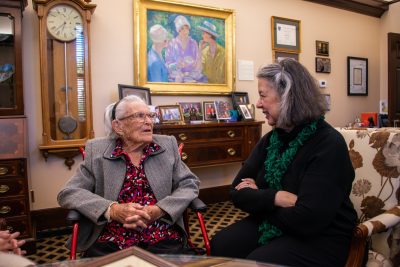 The two women talk in the President's Office.