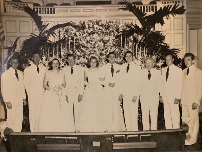 A group wedding photo, everyone in white