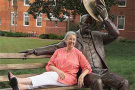 Wendy Libby sits beside the John B. statue