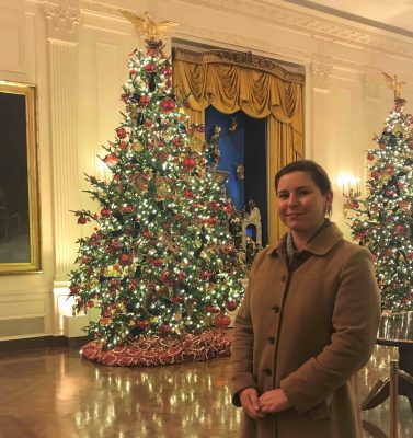 Elizabeth poses in front of large Christmas tree inside the White House