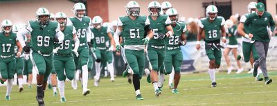 football team runs out on the field