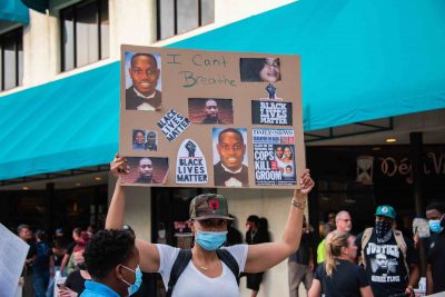 a protester holds up a sign