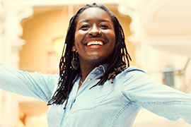 portrait, smiling with her arms out