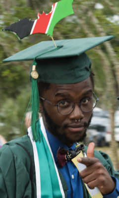 Peter Nyong’o wearing graduation cap and gown and funny bat on the top