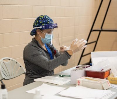 A nurse prepares for a COVID-19 test in the Rinker Field House at Stetson.