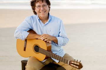 portrait with a guitar at the beach