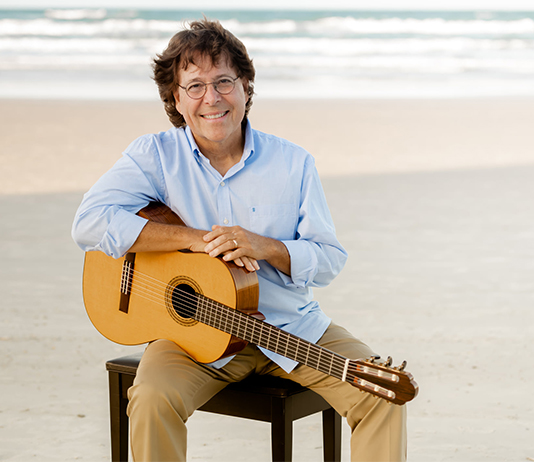 portrait with a guitar at the beach
