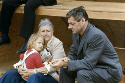 Older man and woman with a child holding a bottle