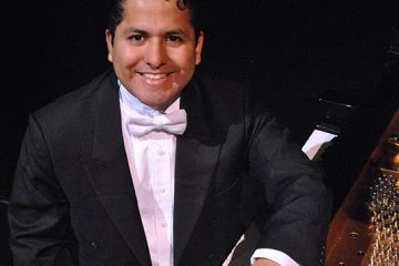 portrait in a tuxedo at a piano
