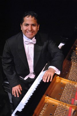 portrait in a tuxedo at a piano