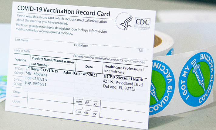 vaccination card sits propped up on table