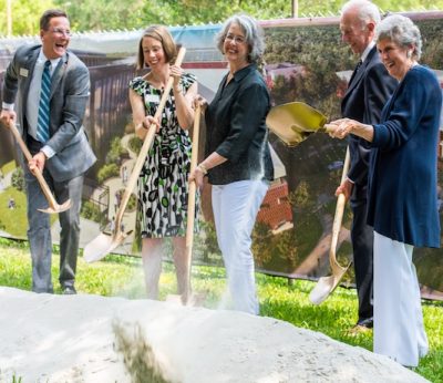 Stetson officials use shovels to move dirt at groundbreaking for Brown Hall.