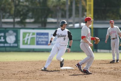 Nick Rickles tags a base during a Hatters baseball game.