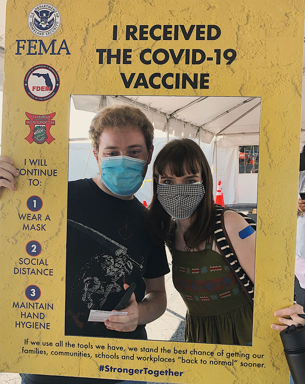 Two students pose at a vaccination site