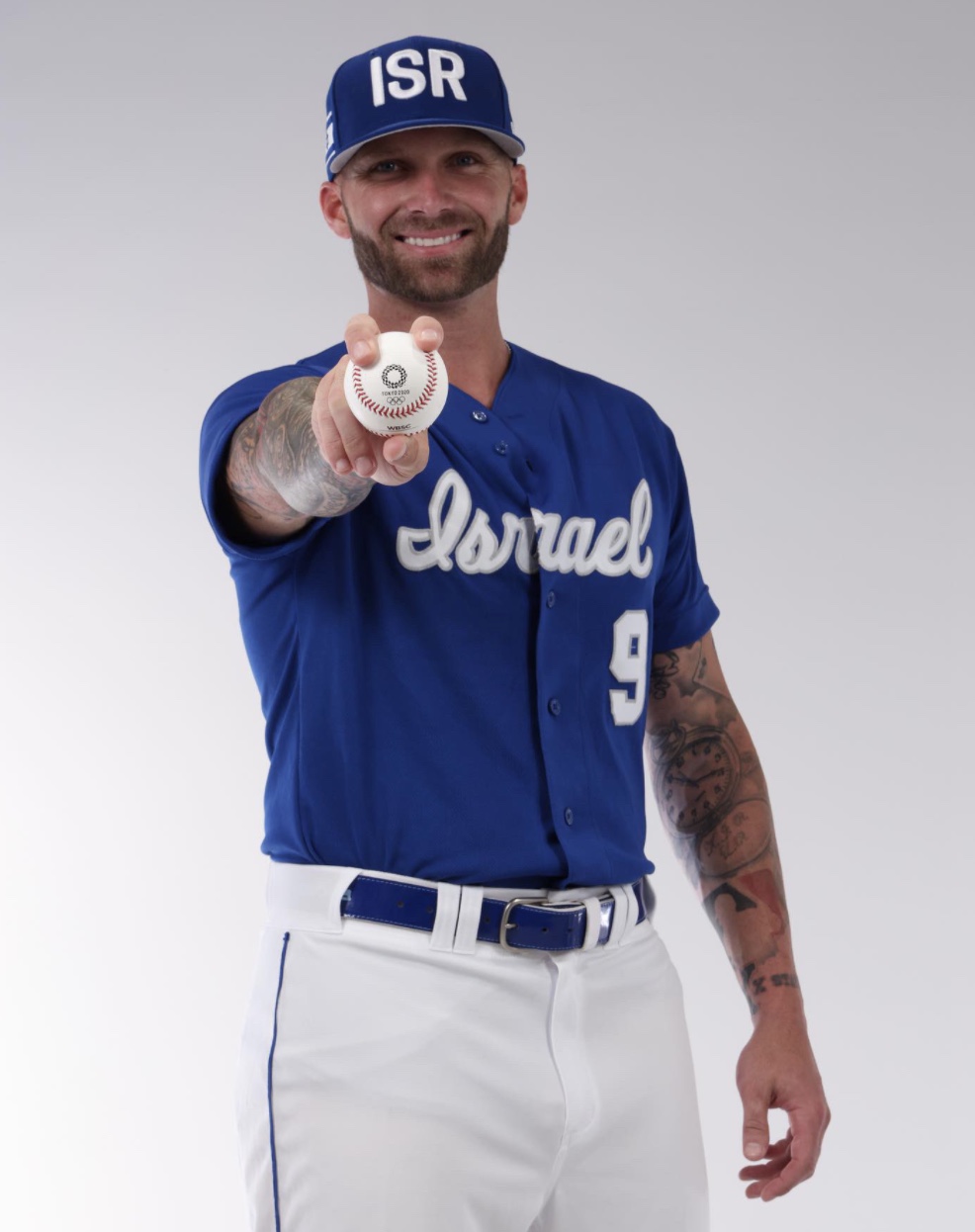 Nick Rickles in Israel baseball uniform holding a baseball.