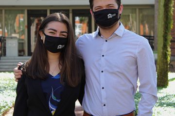 The two SGA officers wear facial coverings in front of duPont-Ball Library.
