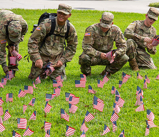 ROTC cadets place little flags near the Stetson flagpole as a flag memorial for 9/11