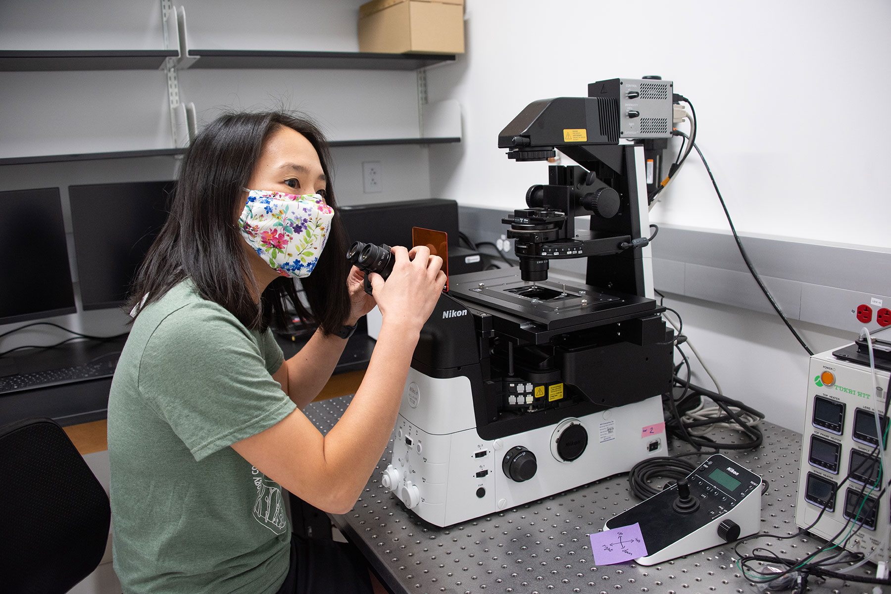 Lynn Kee, PhD, sits at Stetson's high-powered microscope in Sage Hall