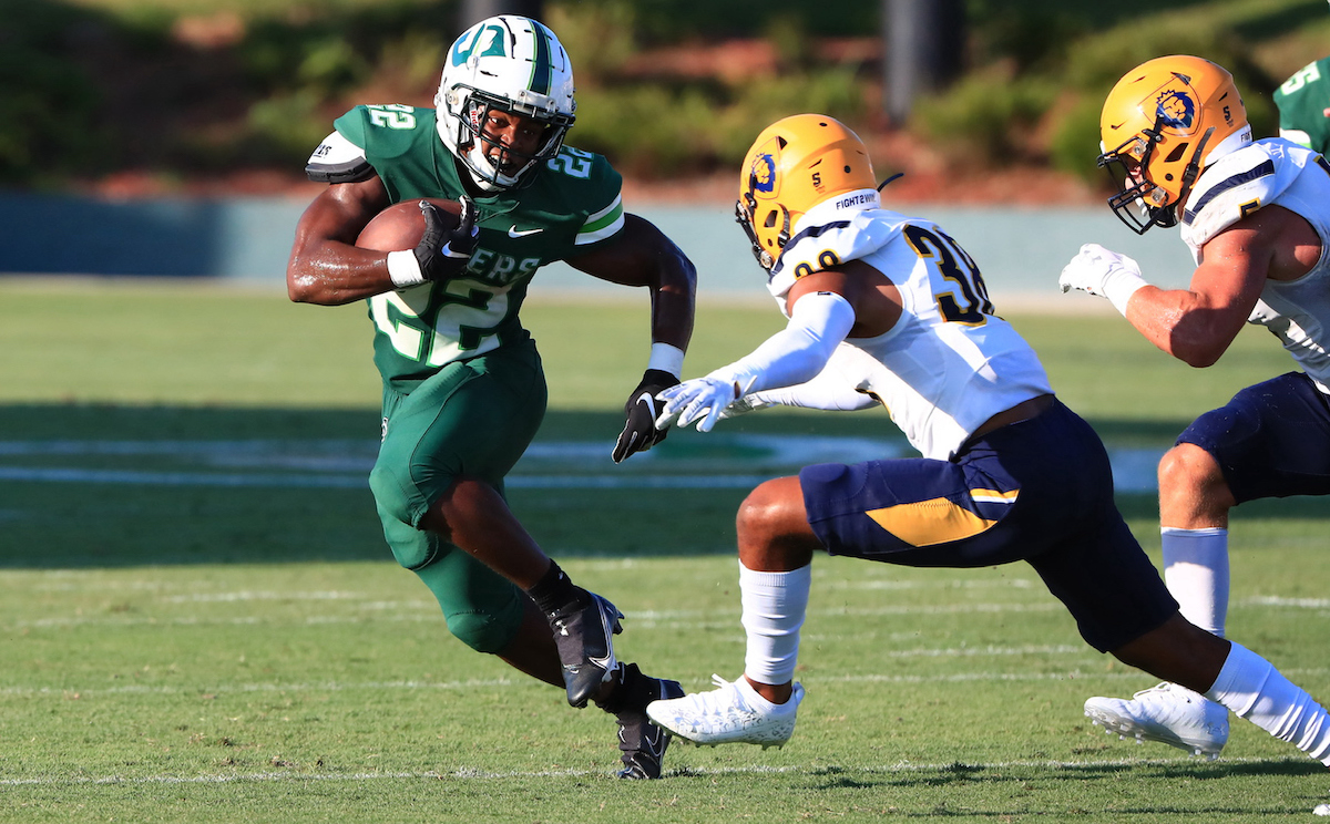 Hatters football player avoids a tackle on the field