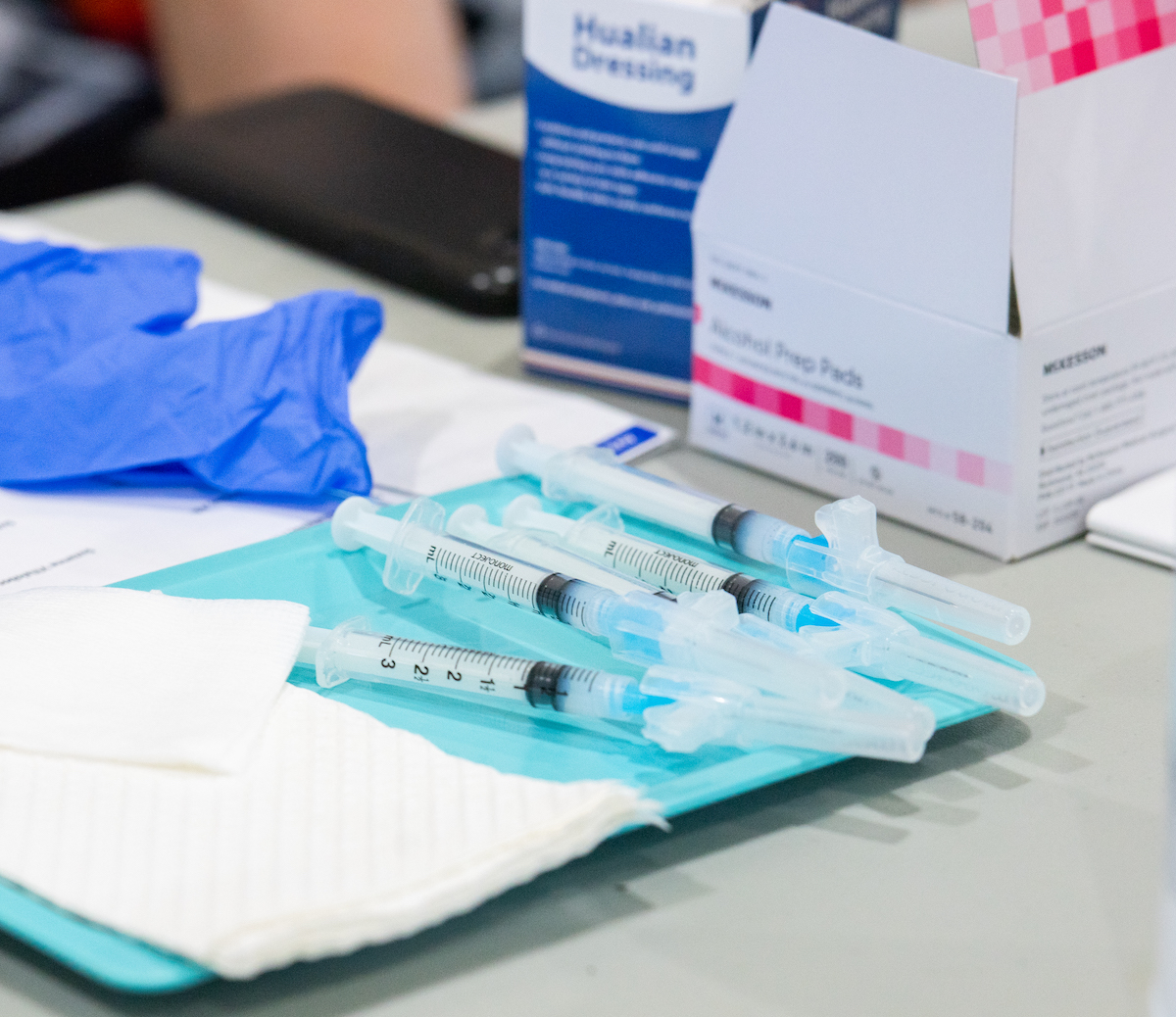 needles of COVID-19 vaccinations are ready on a table, for COVID-19 weekly update.